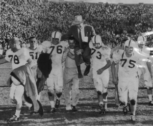 Coach Wilkinson carried from the Notre Dame field in victory in 1956.